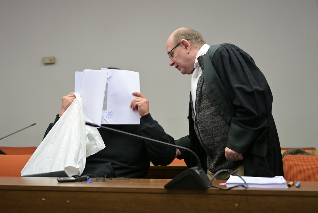 The defendant covers his face as he arrives for a trial against a network of mostly Chinese men, organized in chat groups to advise one another on how to drug and rape mostly Chinese women, in Munich, Germany, Feb. 2, 2026. (Malin Wunderlich/dpa via AP)