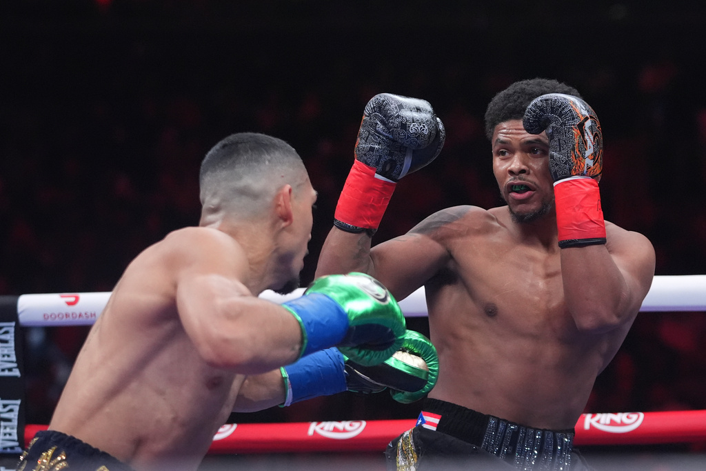 CORRECTS THE NAME TO SHAKUR, NOT SHADUR - Shakur Stevenson, right, fights Teofimo Lopez during a super lightweight title boxing match Sunday, Feb. 1, 2026, in New York. (AP Photo/Frank Franklin II)
