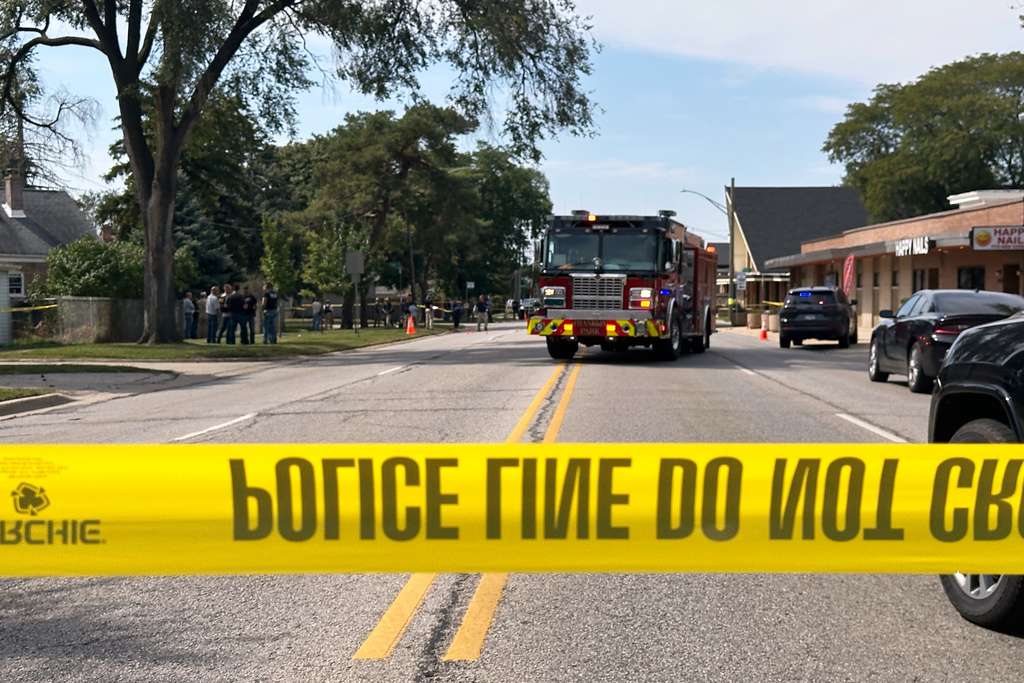 Law enforcement responds to the scene where an Immigration and Customs Enforcement officer shot and killed a suspect after the suspect drove his car at the arresting officers on Friday, Sept. 12, 2025, in Franklin Park, Ill. (AP Photo/Laura Bargfeld)