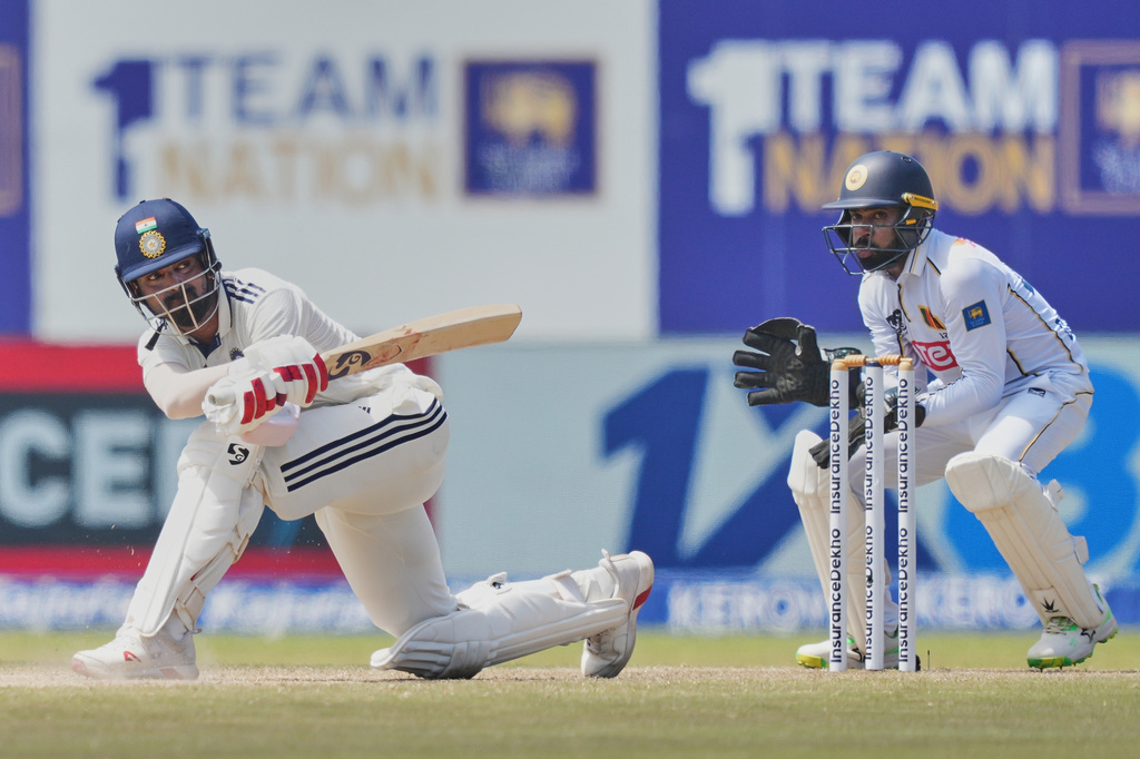 India's KL Rahul plays a shot as Sri Lanka's Niroshan Dickwella watches during the day four of the first cricket test match between Sri Lanka and India in Galle, Sri Lanka, Tuesday, Aug. 18, 2026. (AP Photo/Eranga Jayawardena)