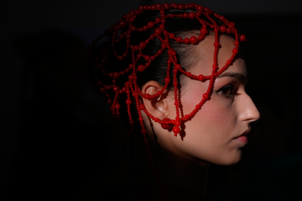 A model is prepared for a runway show at the backstage of the Moscow Fashion Week in Moscow, Saturday, March 14, 2026. (AP Photo/Pavel Bednyakov)