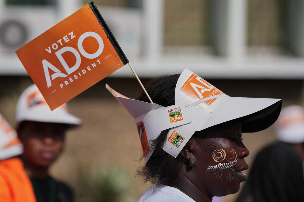 A supporter of President Alassane Ouattara wears a hat during a campaign rally in Abidjan, Ivory Coast, Thursday, Oct. 23, 2025. (AP Photo/Misper Apawu)