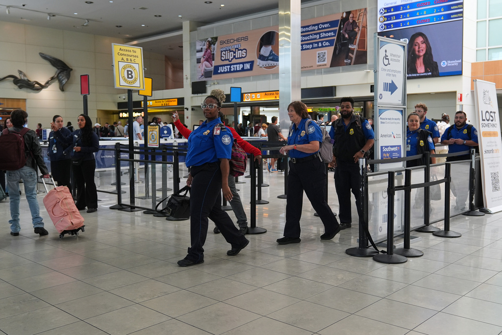 Transportation Security Administration employees leave a security checkpoint during a shift change at Baltimore/Washington International Thurgood Marshall Airport, Thursday, Oct. 2, 2025, in Baltimore. (AP Photo/Stephanie Scarbrough)