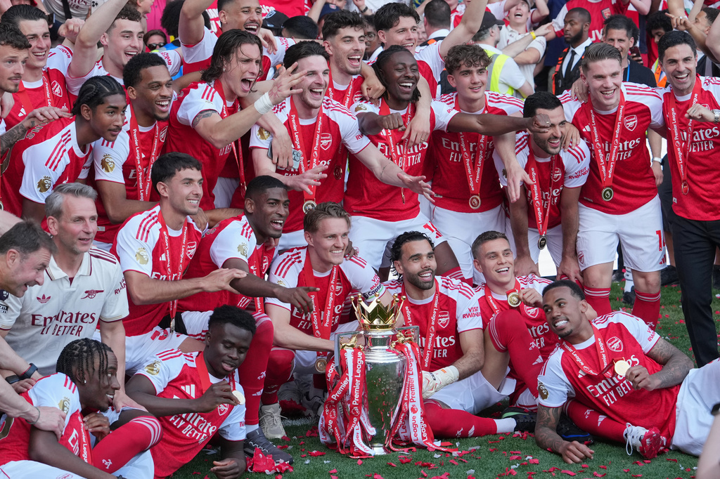 Arsenal players celebrate their Premier League title with the trophy after the English Premier League soccer match between Crystal Palace and Arsenal in London, England, Sunday, May 24, 2026. (AP Photo/Kin Cheung)