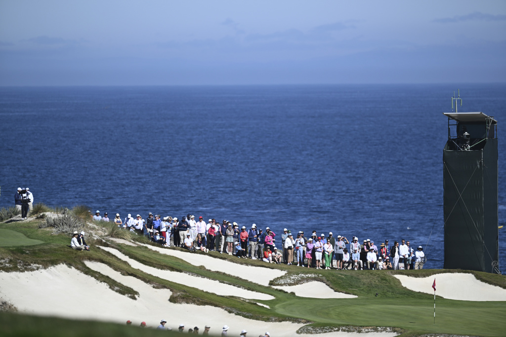 Fans watch play on the 13th green during Walker Cup golf matches between the USA team and The Great Britain and Ireland team at Cypress Point Club on Sunday, Sept. 7, 2025, in Pebble Beach, Calif. (AP Photo/Thien-An Truong )