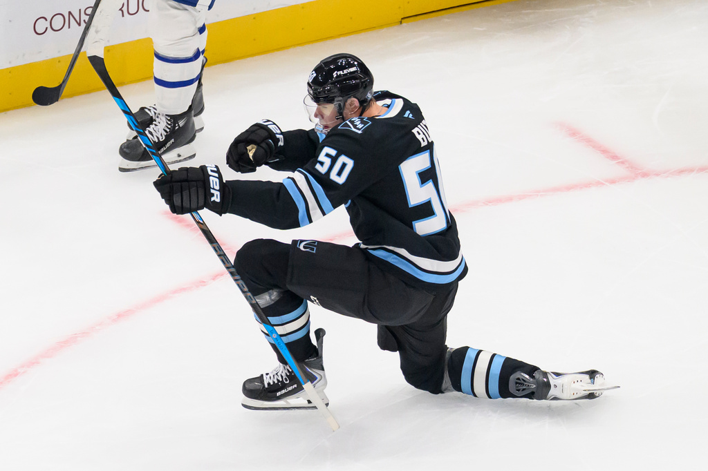 Utah Mammoth left wing Daniil But (50) celebrates scoring during the first period of an NHL hockey game against the Toronto Maple Leafs, Tuesday, Oct. 13, 2026, in Salt Lake City. (AP Photo/Tyler Tate)