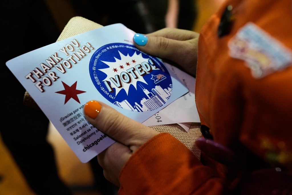 Democratic candidate for Congress, Kat Abughazaleh, holds a "Thank you for voting" sticker after voting in the Illinois primary election for the upcoming midterms, in Chicago, Tuesday, March 17, 2026. (AP Photo/Nam Y. Huh)