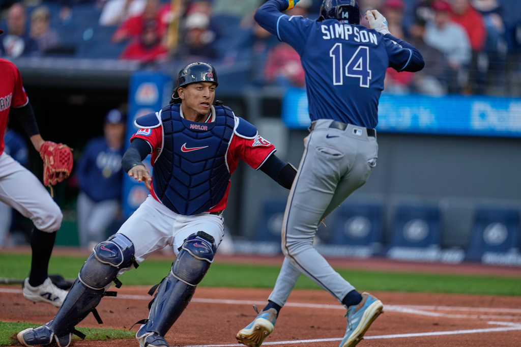 Cleveland Guardians catcher Bo Naylor, left, covers as Tampa Bay Rays' Chandler Simpson (14) attempts to run home but was called out in the first inning of a baseball game in Cleveland, Tuesday, April 28, 2026. (AP Photo/Sue Ogrocki)