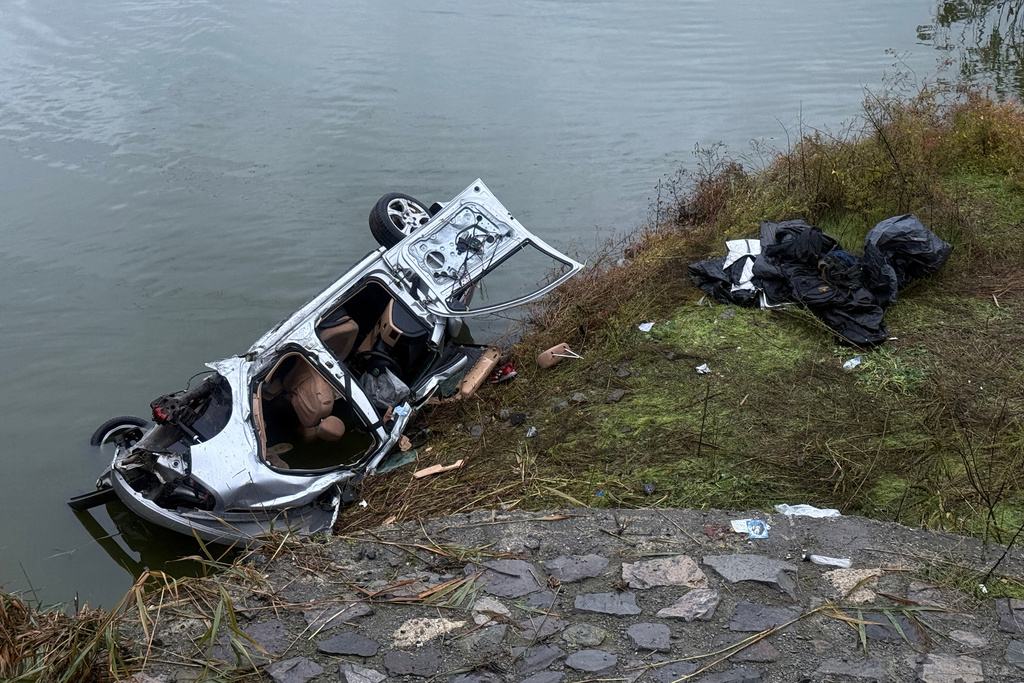 A vehicle is seen crashed out of a road after a police chase near Burgas, Bulgaria, Friday 7 Nov. 2025. (NOVA TV Bulgaria via AP)