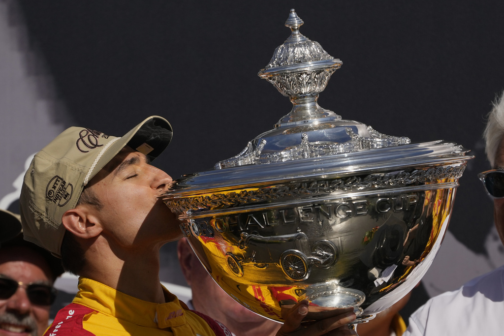 Alex Palou kisses the trophy as he celebrates winning the IndyCar championship Sunday, Aug. 31, 2025, at Nashville Superspeedway in Lebanon, Tenn. (AP Photo/George Walker IV)