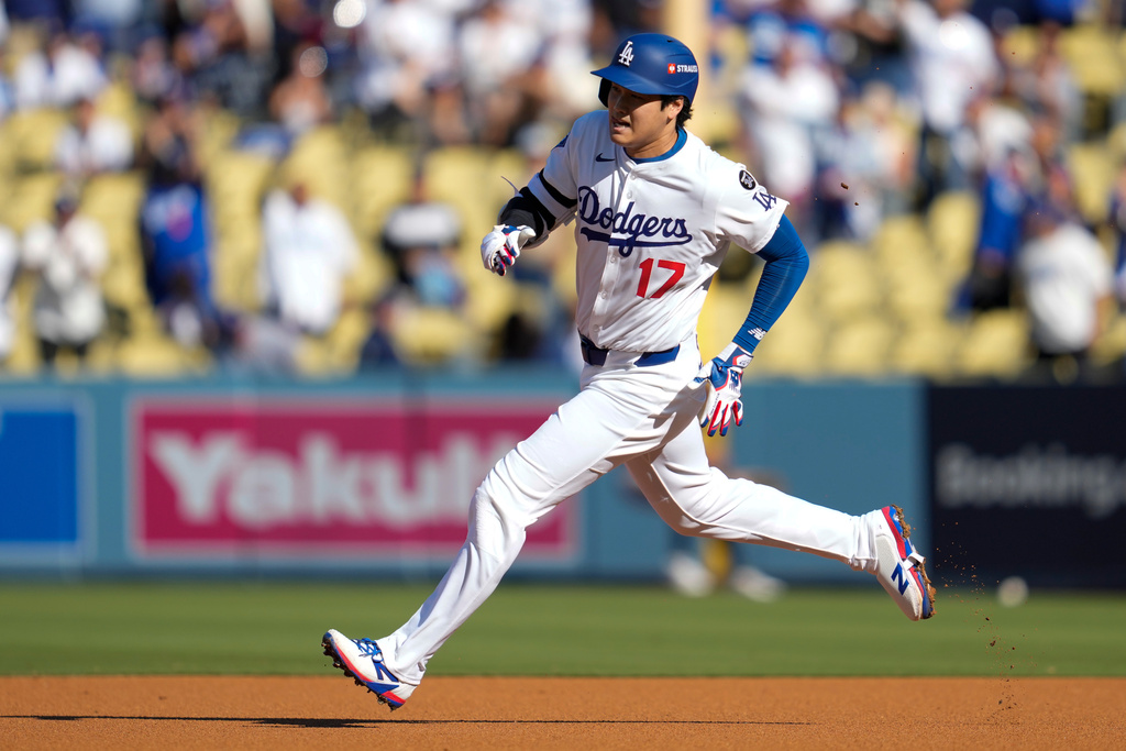Los Angeles Dodgers' Shohei Ohtani rounds the bases after a triple against the Milwaukee Brewers during the first inning in Game 3 of baseball's National League Championship Series, Thursday, Oct. 16, 2025, in Los Angeles. (AP Photo/Ashley Landis)