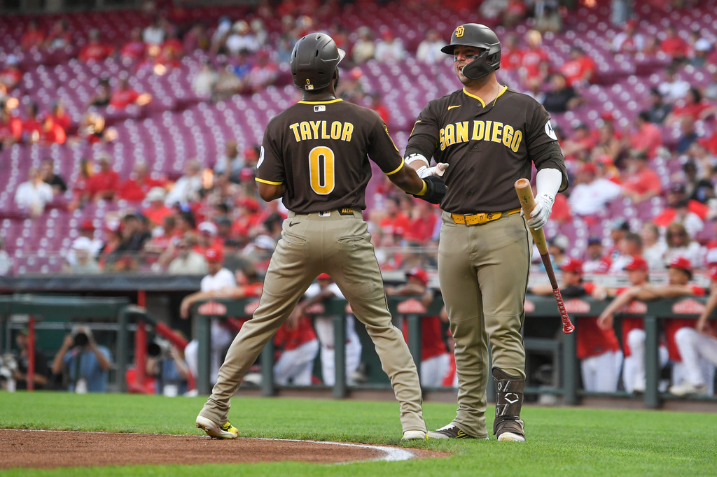 San Diego Padres' Samad Taylor celebrates with Ty France after scoring on a sacrifice fly by Manny Machado during the first inning of a baseball game against the Cincinnati Reds, Tuesday, Sept. 1, 2026, in Cincinnati. (AP Photo/Tanner Pearson)