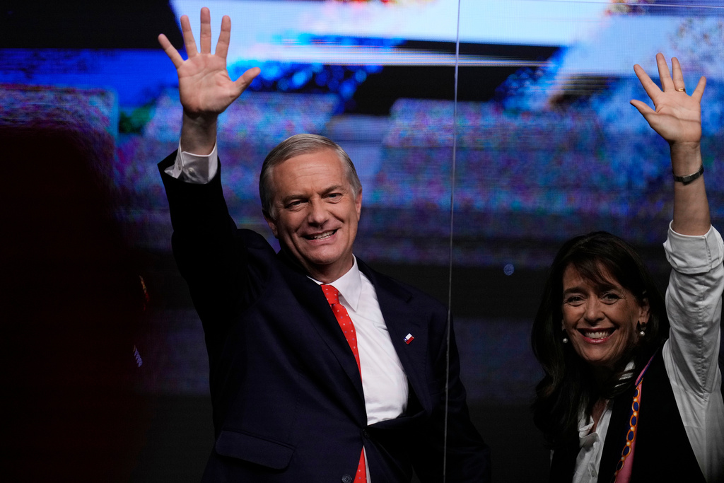 Presidential candidate Jose Antonio Kast of the Republican Party, and his wife Maria Pia Adriasola, wave to supporters after early results in the general elections in Santiago, Chile, Sunday, Nov. 16, 2025. (AP Photo/Esteban Felix)