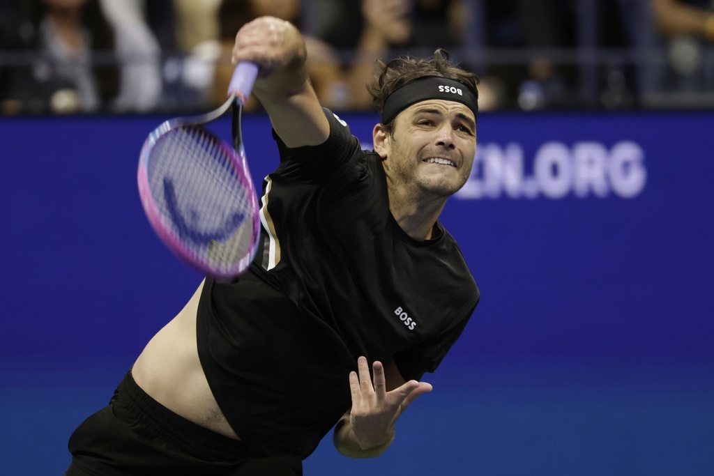 Taylor Fritz, of the United States, serves against Novak Djokovic, of Serbia, during the quarterfinal round of the U.S. Open tennis championships, Tuesday, Sept. 2, 2025, in New York. (AP Photo/Adam Hunger)