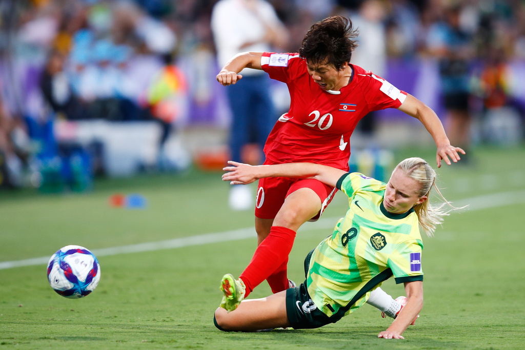 North Korea's Chae Un Yong, left, and Australia's Kaitlyn Torpey battle for the ball during the Women's Asian Cup quarterfinal soccer match between Australia and North Korea in Perth, Australia, Friday, March 13, 2026. (AP Photo/Gary Day)