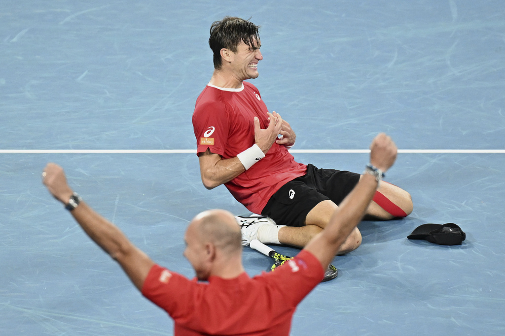 Raphael Collignon of Belgium celebrates after defeating Aleksandar Vukic of Australia to take the Davis Cup qualifying second round match at Ken Rosewall Arena in Sydney, Sunday, Sept. 14, 2025. (Dean Lewins/AAP Image via AP)