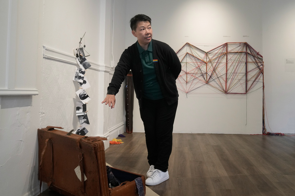 OUT Museum founder Xiangqi Chen gestures toward her art piece, "The Weight of Kindness," displayed at the Chinatown museum, Monday, June 22, 2026, in San Francisco. (AP Photo/Jeff Chiu)