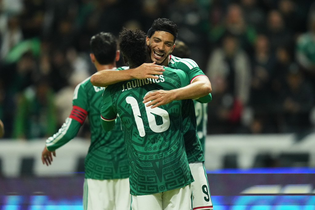 Mexico's Raúl Jiménez, is congratulated after scoring his side's 3rd goal against Serbia during an international friendly soccer match in Toluca, Mexico, Thursday, June 4, 2026. (AP Photo/Moises Castillo)