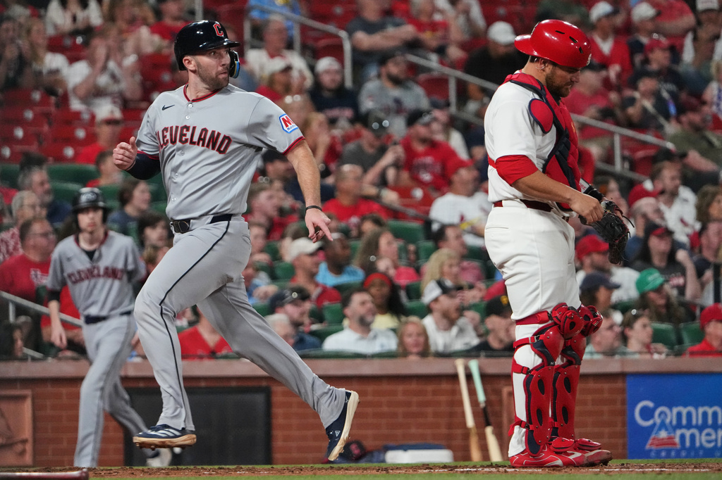 Cleveland Guardians' David Fry, left, scores past St. Louis Cardinals catcher Pedro Pagés during the fourth inning of a baseball game Monday, April 13, 2026, in St. Louis. (AP Photo/Jeff Roberson)