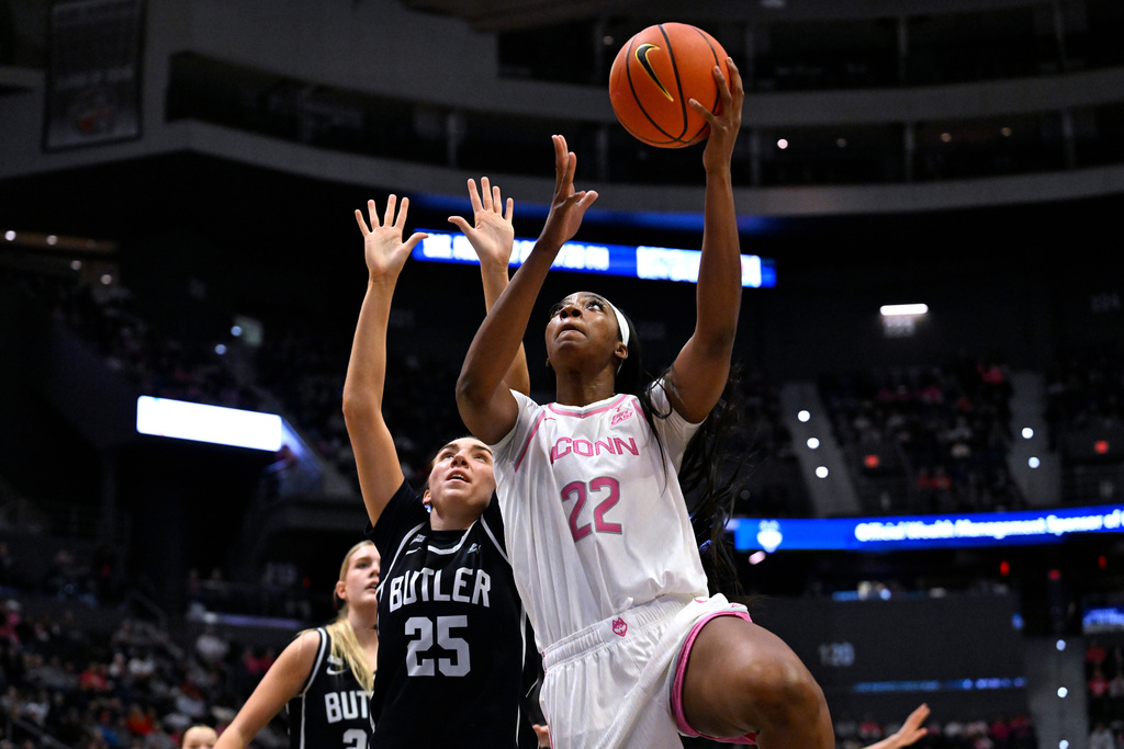UConn forward Serah Williams (22) makes a basket past Butler forward Caroline Dotsey (25) in the first half of an NCAA college basketball game, Saturday, Feb. 7, 2026, in Hartford, Conn. (AP Photo/Jessica Hill)