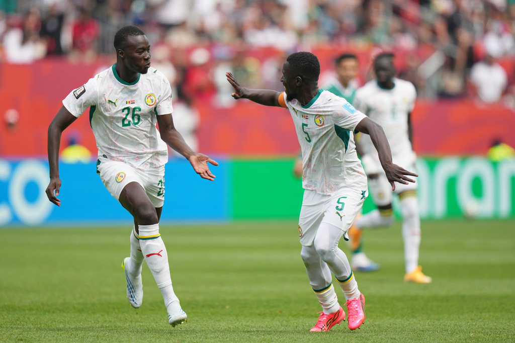 Senegal's Pape Gueye (26) celebrates with Idrissa Gana Gueye (5) after scoring their third goal during the World Cup Group I soccer match between Senegal and Iraq in Toronto, Friday, June 26, 2026. (AP Photo/Stephanie Scarbrough)