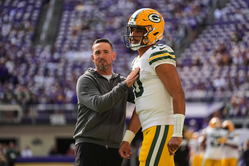 Green Bay Packers head coach Matt LaFleur, left, talks with quarterback Jordan Love, right, during warmups before an NFL football game against the Minnesota Vikings, Sunday, Sept. 13, 2026, in Minneapolis, Minn. (AP Photo/Abbie Parr)