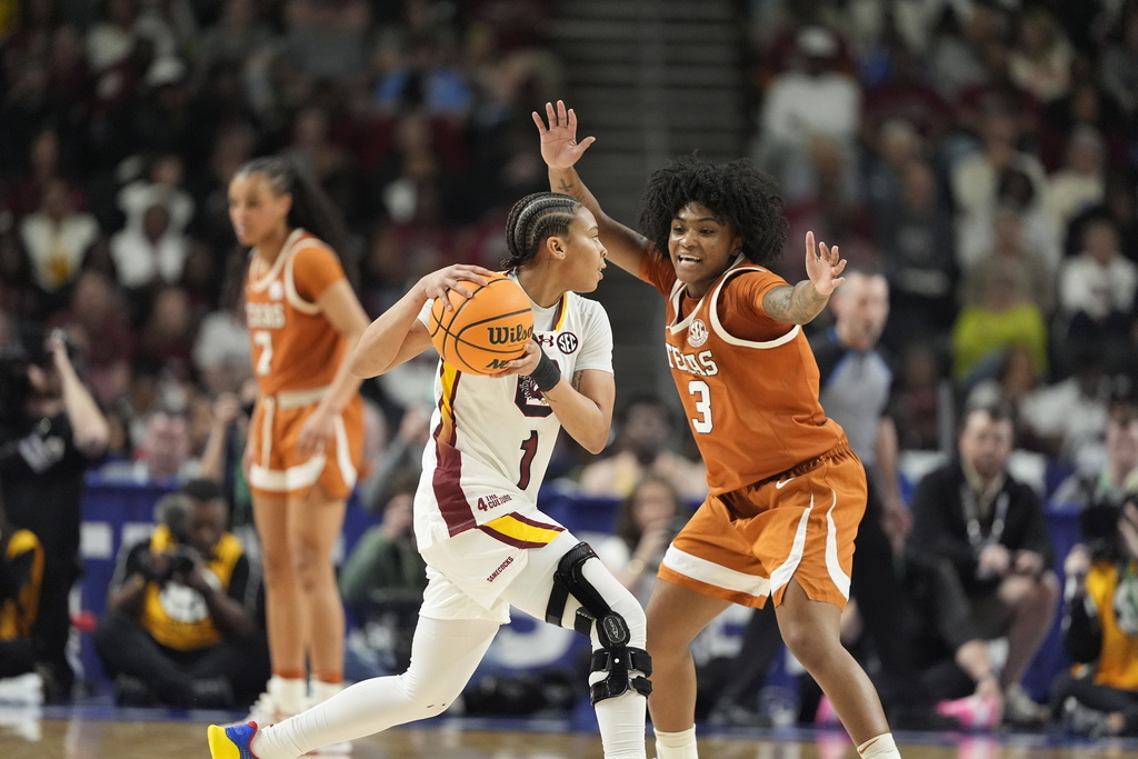 Texas guard Rori Harmon guards South Carolina guard Maddy McDaniel during the first half of an NCAA college basketball game in the final of the Southeastern Conference tournament, Sunday, March 8, 2026, in Greenville, S.C. (AP Photo/Chris Carlson)