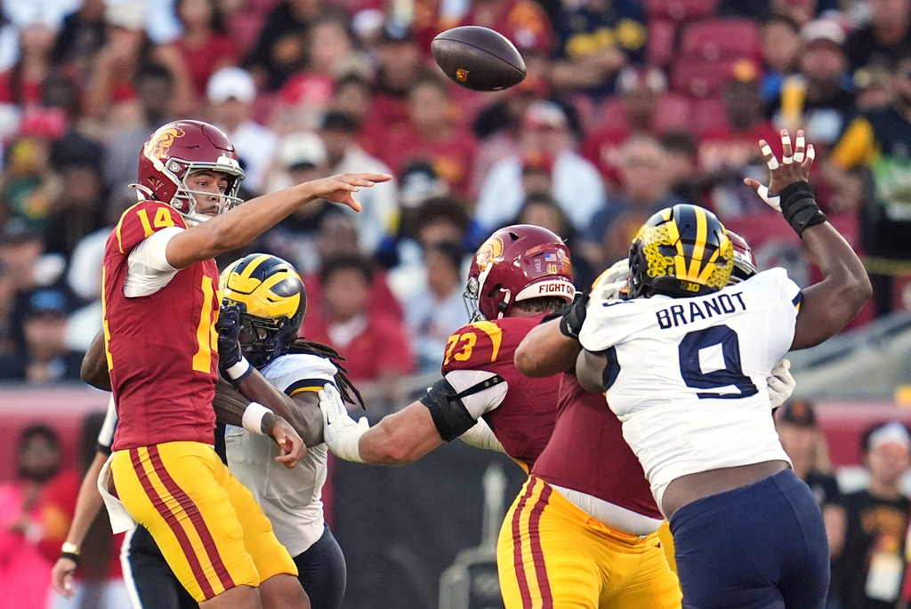 Southern California quarterback Jayden Maiava (14) throws under pressure during the first half of an NCAA college football game against Michigan, Saturday, Oct. 11, 2025, in Los Angeles. (AP Photo/Marcio Jose Sanchez)