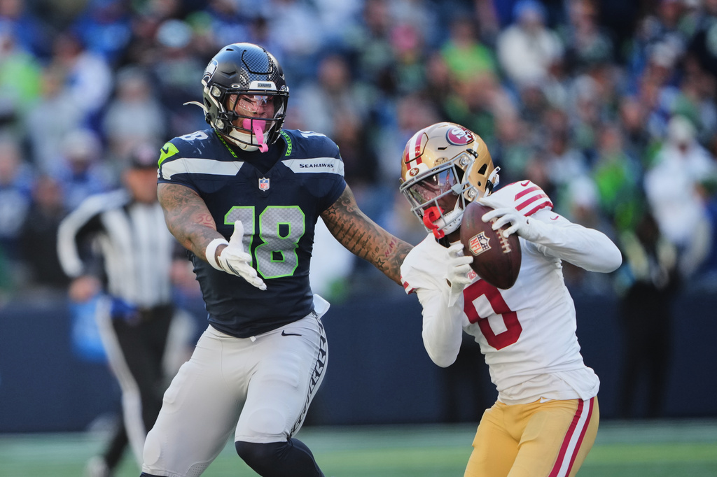 San Francisco 49ers cornerback Renardo Green (0) intercepts a pass intended for Seattle Seahawks tight end Elijah Arroyo (18) during the second half of an NFL football game Sunday, Oct. 11, 2026, in Seattle. (AP Photo/Lindsey Wasson)