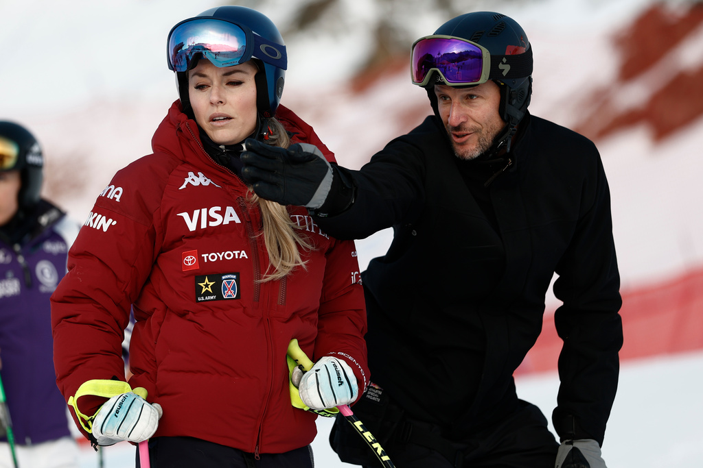 United States' Lindsey Vonn listens to Aksel Lund Svindal ahead of an alpine ski, women's World Cup downhill in St. Moritz, Switzerland, Friday Dec. 12, 2025. (AP Photo/Gabriele Facciotti)