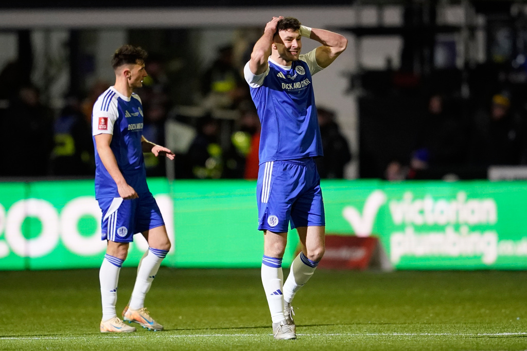 Macclesfield's Sam Heathcote reacts after scoring own goal during the English FA cup fourth round soccer match between Macclesfield and Brentford in Macclesfield, England, Monday, Feb. 16, 2026. (AP Photo/Dave Thompson)