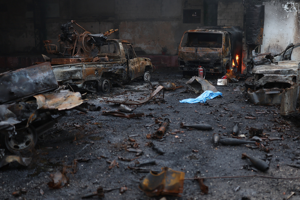 Burned vehicles and ammunitions left at one of the Kurdish fighters positions at the Sheikh Maqsoud neighborhood, where clashes between government forces and Kurdish fighters have been taking place in the northern city of Aleppo, Syria, Sunday, Jan. 11, 2026. (AP Photo/Ghaith Alsayed)
