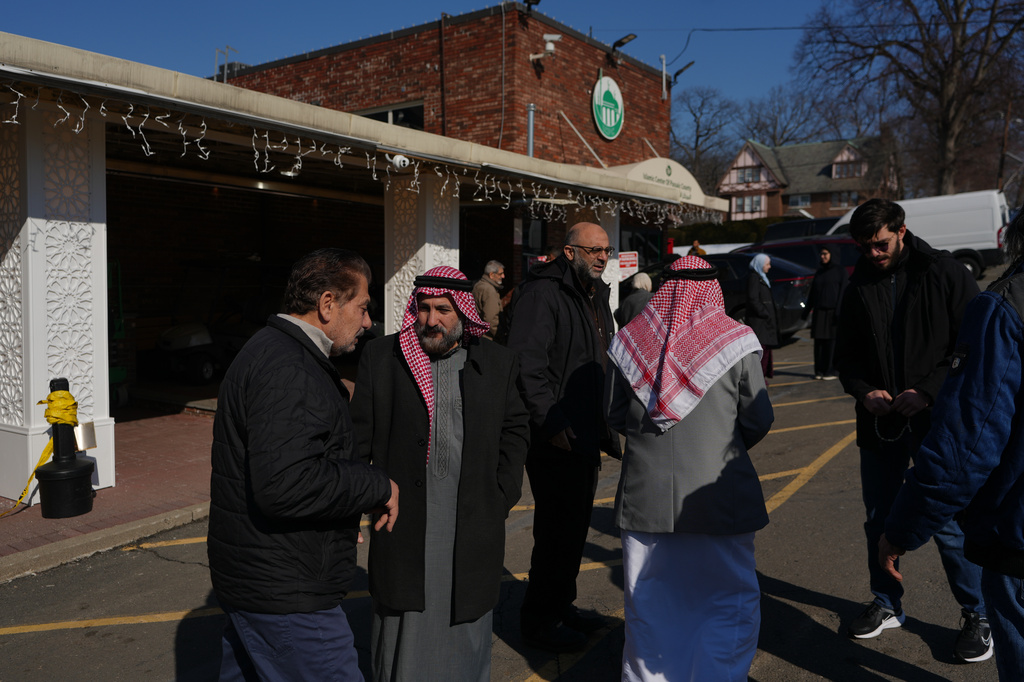 Congregants greet each other during Ramadan after attending prayers at the Islamic Center of Passaic County in Paterson, N.J., on Friday, Feb. 27, 2026. (AP Photo/Luis Andres Henao)