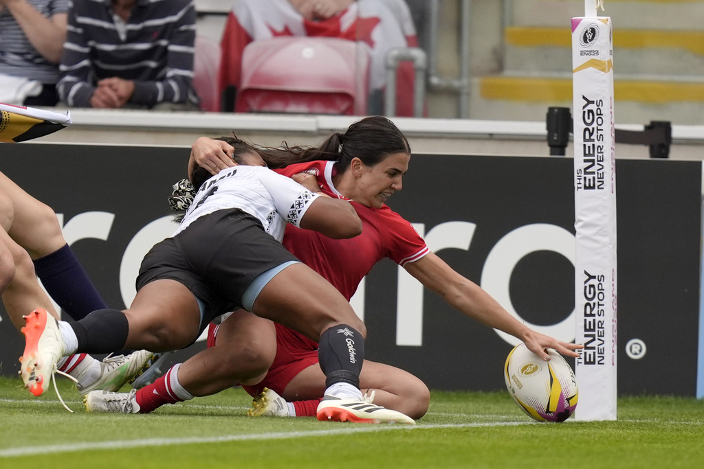 Canada's Julia Schell scores a try during the Women's Rugby World Cup 2025 Pool B match between Canada and Fiji at the York Community Stadium in York, England, Saturday, Aug. 23, 2025. (Danny Lawson/PA via AP)