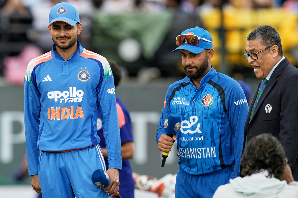 India's captain Shubman Gill, left, and Afghanistan's captain Hashmatullah Shahidi look after the coin toss ahead of the first ODI cricket match between Afghanistan and India in Dharamshala, India, Saturday, June 13, 2026. (AP Photo/Ashwini Bhatia)