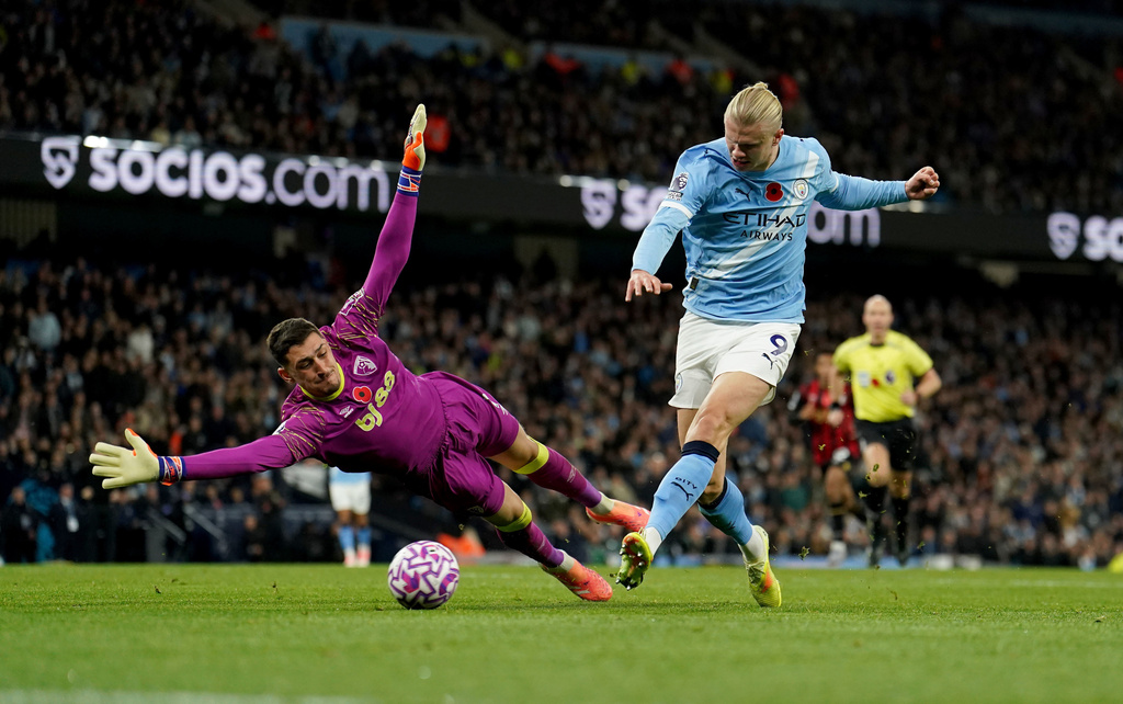 Manchester City's Erling Haaland scores his side's second goal past Bournemouth's goalkeeper Dorde Petrovic during the English Premier League soccer match between Manchester City and Bournemouth in Manchester, England, Sunday, Nov. 2, 2025. (Martin Rickett/PA via AP)