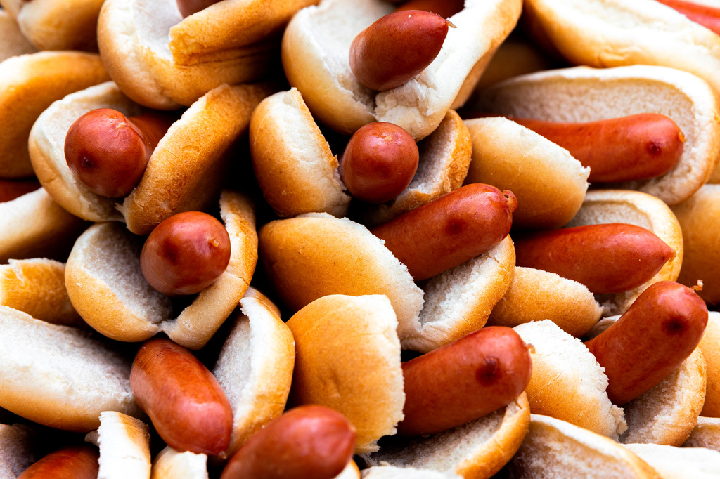 FILE - A Nathan's employee arranges 76 hot dogs on a plate at a weigh-in before the Nathan's Famous July Fourth hot dog eating contest, July 1, 2022, in New York. (AP Photo/Julia Nikhinson, File)