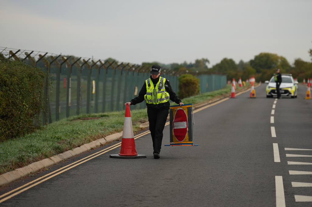 Police officers guard a road leading to RAF Fairford, after an incident in Fairford, England, Monday Sept. 28, 2026. (AP Photo/Alastair Grant)