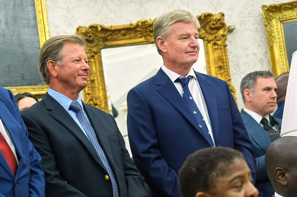 FILE - South African golfers Retief Goosen, left, and Ernie Els look on as President Donald Trump meets South African President Cyril Ramaphosa in the Oval Office of the White House, May 21, 2025, in Washington. (AP Photo/Evan Vucci, File)