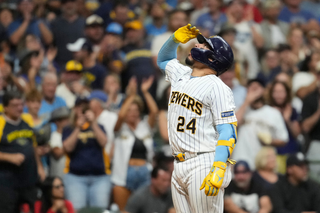 Milwaukee Brewers' William Contreras gestures as he rounds the bases after hitting a three-run home run during the fourth inning of a baseball game against the Cincinnati Reds, Saturday, Sept. 12, 2026, in Milwaukee. (AP Photo/Aaron Gash)