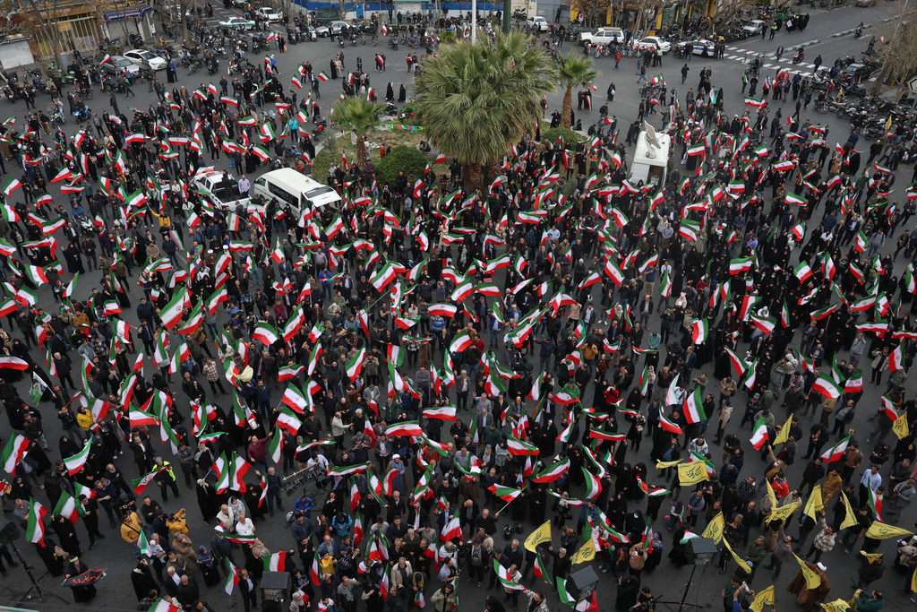 A group of demonstrators wave Iranian flags in support of the government and against U.S. and Israeli strikes in Tehran, Iran, Saturday, Feb. 28, 2026. (AP Photo/Vahid Salemi)