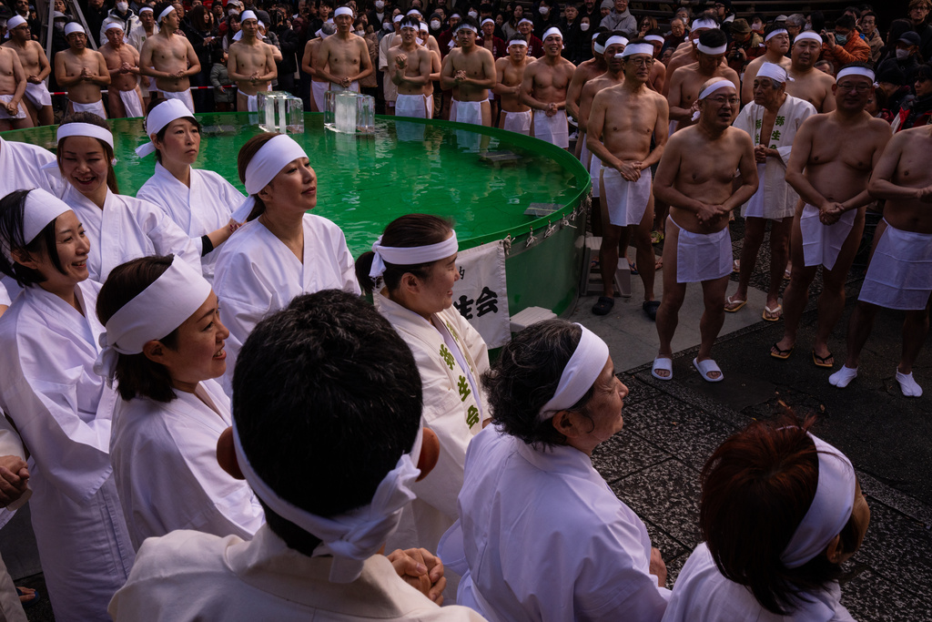 Participants prepare to bathe in ice-cold water to purify their souls and pray for good health during a New Year's ritual at Teppozu Inari Shrine in Tokyo, Sunday, Jan. 11, 2026. (AP Photo/Louise Delmotte)