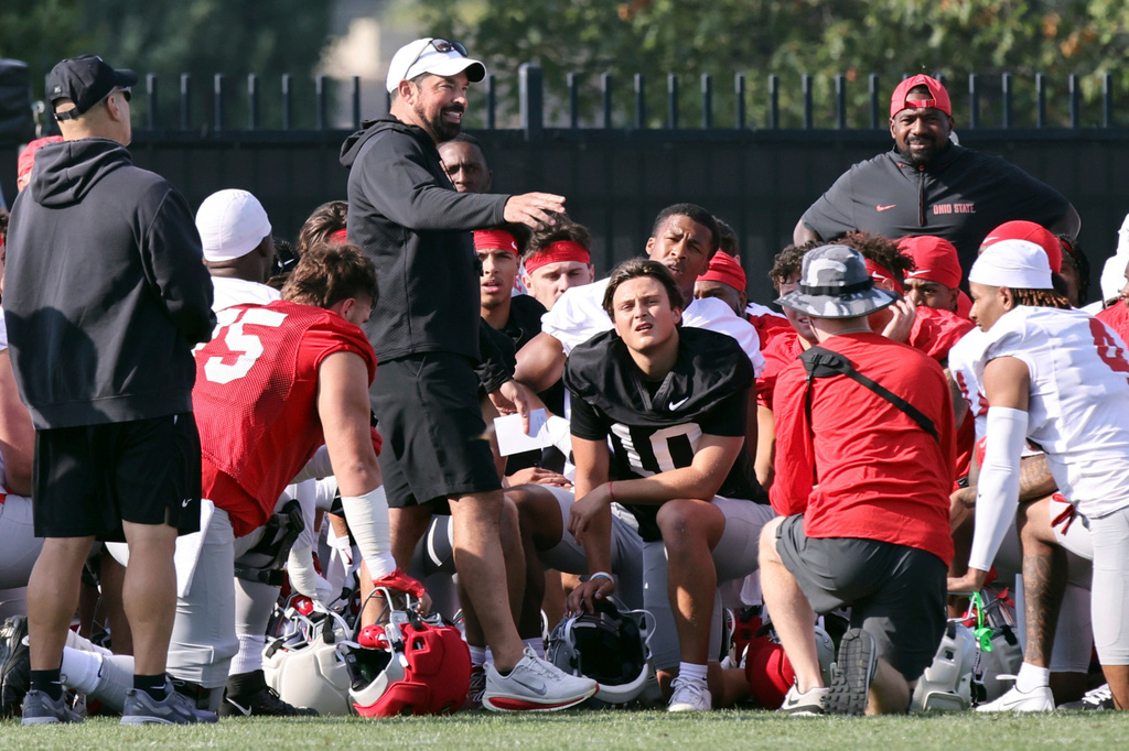 FILE - Ohio State coach Ryan Day talks to his team during NCAA college football practice in Columbus, Ohio, Aug. 1, 2025. (AP Photo/Paul Vernon, File)