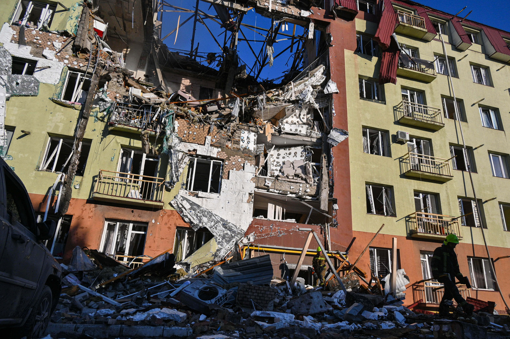 A rescue worker walks in front of residential building which was heavily damaged after a Russian strike in Odesa, Ukraine, Monday, April 6, 2026. (AP Photo/Michael Shtekel)