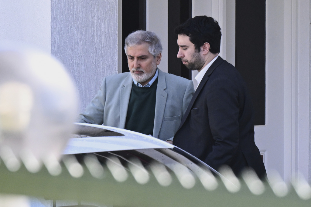 Iranian ambassador to Australia Ahmad Sadeghi, left, is assisted to a car as he leaves the Embassy of the Islamic Republic of Iran in Canberra, Australia, Wednesday, Aug. 27, 2025. (Lukas Coch/AAP Image via AP)