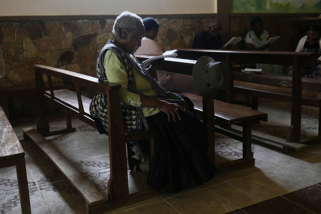 Angelica Larrea, wife of Julio Pinedo, a symbolic leader who is regarded as the king of the Afro-Bolivians, attends a service at the Catholic Church of Tocana, Bolivia, Sunday, Aug. 3, 2025. (AP Photo/Juan Karita)