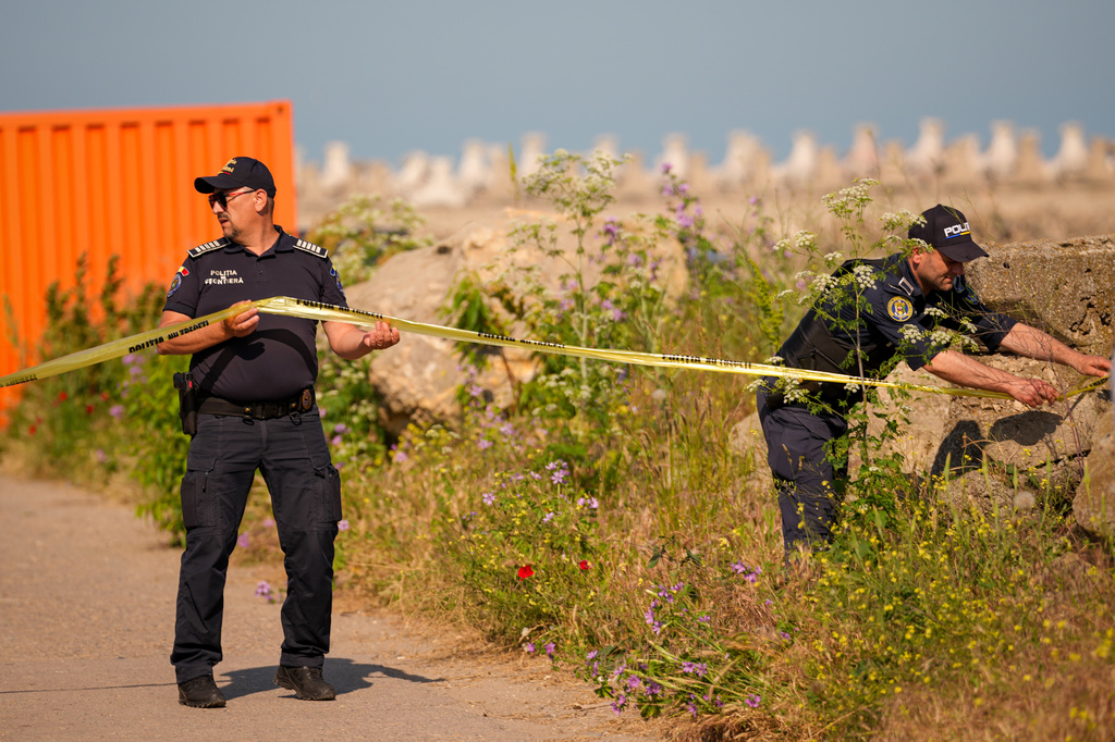 Romanian Border Police officers secure an entrance in the vicinity of a damaged warehouse following the explosion of a maritime drone in the Black Sea port of Constanta, Romania, Friday, June 5, 2026. (AP Photo/Vadim Ghirda)
