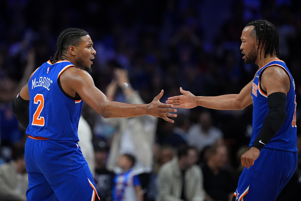 New York Knicks' Miles McBride, left, and Jalen Brunson celebrate during the first half of Game 4 against the Philadelphia 76ers in a second-round NBA basketball playoffs series Sunday, May 10, 2026, in Philadelphia. (AP Photo/Matt Slocum)
