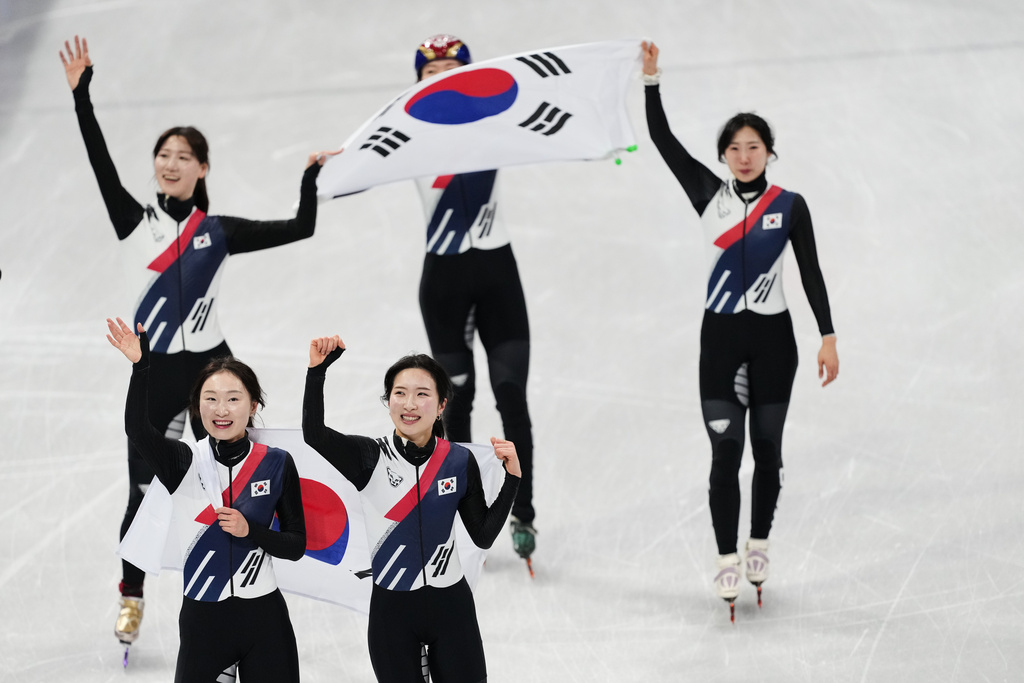 Team Korea celebrate winning the gold during the short track speed skating women's team 3000m relay final at the 2026 Winter Olympics, in Milan, Italy, Wednesday, Feb. 18, 2026. (AP Photo/Francisco Seco)