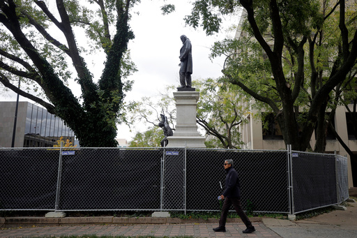 A person walks past the closed off area around where a statue of Confederate general Albert Pike has been reinstalled near the headquarters of the Department of Labor, Tuesday, Oct. 28, 2025, in Washington. (AP Photo/Rahmat Gul) A person walks past the closed off area around where a statue of Confederate general Albert Pike has been reinstalled near the headquarters of the Department of Labor, Tuesday, Oct. 28, 2025, in Washington. (AP Photo/Rahmat Gul)